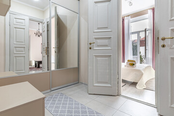 Bright Hallway with Open Doors Leading to Bedroom