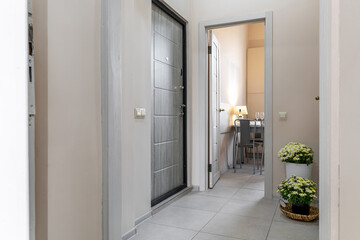 Modern Entryway with Flowers and Open Door to Kitchen