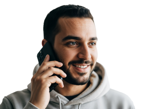 Man talking on the phone in a casual setting during the day with a friendly expression and relaxed attire