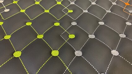 Obraz premium Modern quilted pattern with vibrant green and gray stitching on black synthetic leather for stylish backgrounds