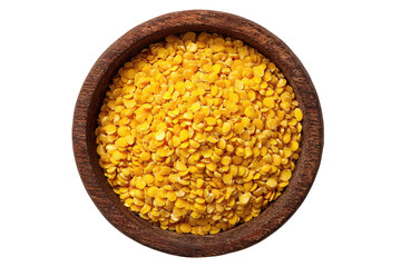 Split yellow lentils in a dark wooden bowl, overhead view