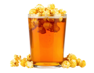 A glass filled with a fizzy drink topped with buttery popcorn, creating a unique and playful snack experience.
