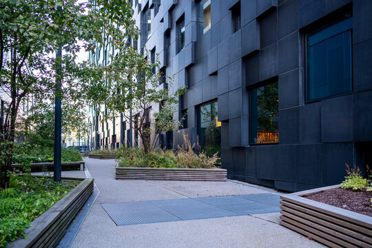 Long urban promenade framed by architecture edges, minimal tones, linear perspective ground copyspace, refined geometry, clear space, extended city urbanscape streetscape