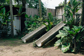 Two Concrete Slides Amid Lush Greenery
