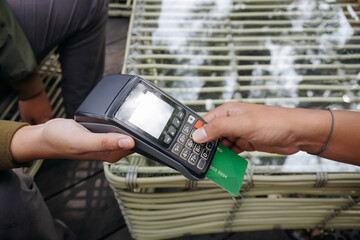 Person Inserting Card into Payment Terminal