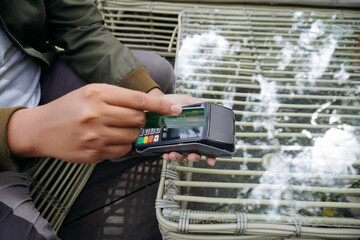 Person Swiping Green Credit Card in Card Reader