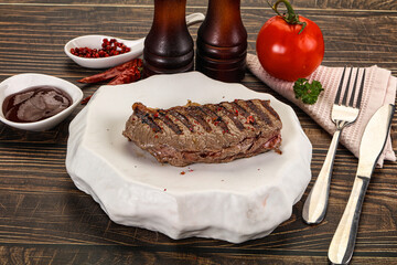 Grilled beef striploin steak with sauce