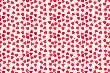 Abstract pattern of small red heart shapes on a white background