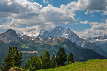 marmolada mountain range seen from the trail that lead from Passo Sella to the Friedrich August refuge with a cloudy sky in the background, Dolomites, Italy