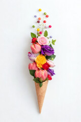 Ice cream cone filled with colorful spring flowers