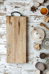 Rustic wooden cutting board with spices and honey