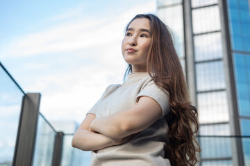 Confident young woman enjoying city life on a rooftop. Concept of female empowerment, independence, self confidence, and modern lifestyle