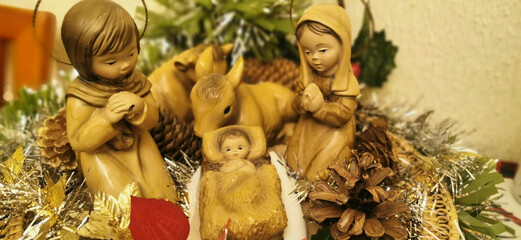 Representation of the nativity with three figures: Jesus, a baby and a donkey, symbolizing the Christmas story in a classical context