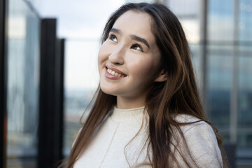Asian woman on a rooftop with an open smile, glowing skin and white teeth — evokes freshness, health and vitality; ideal for ads for nutrition, probiotics, dental care, skincare and wellness