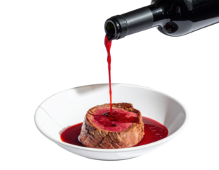 A succulent piece of meat served in a white bowl, with red wine being poured over it, creating a rich, appetizing presentation.
