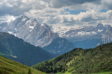 Fototapeta premium Sella mountain range and Sasso Pordoi images from Col Rodella with a cloudy sky in the background, Dolomites, Italy