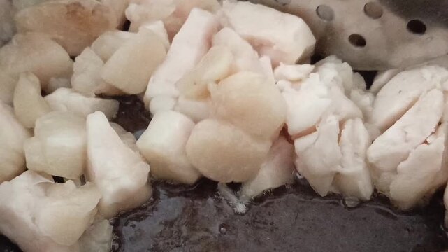 Beef fat is fried in a saucepan. Melted fat, ghee butter