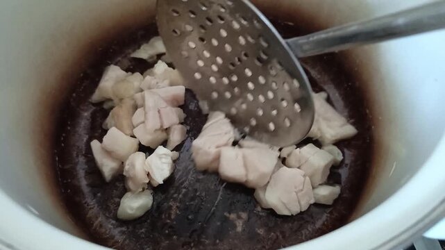 Beef fat is fried in a saucepan. Melted fat, ghee butter