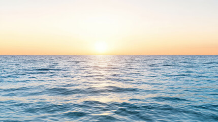 Obraz premium Sunset over calm ocean water with gentle waves reflecting warm colors