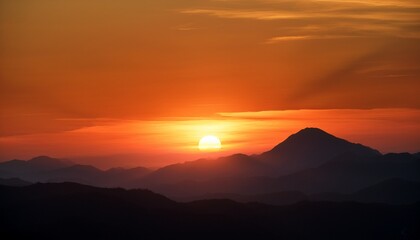 Sunset Mountains Orange Sun Sets Behind Silhouetted Hills At Dusk Creating Warm Orange Sky Because Of Atmospheric Effect