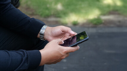 Man Using Smartphone Outdoors Wearing a Watch