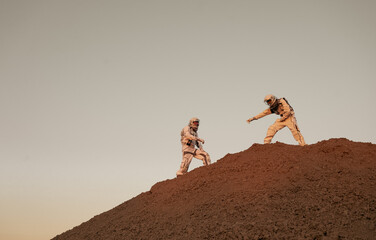 Astronauts demonstrating support and cooperation on the red planet during space mission.