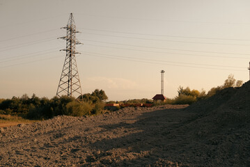 High-voltage power lines on red soil landscape