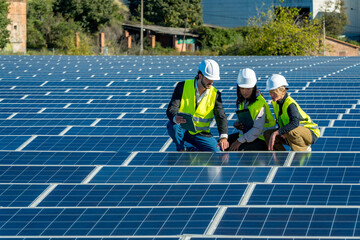 Solar engineers team inspecting photovoltaic panels at farm