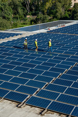 Engineers walking on solar panels producing clean energy
