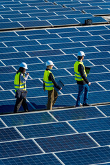 Engineers inspecting solar panels at renewable energy power plant © unai