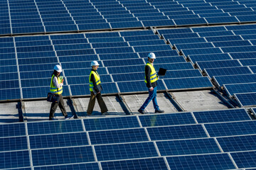 Engineers inspecting solar panels at renewable energy plant