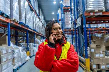 Woman warehouse worker receiving phone call in cold storage