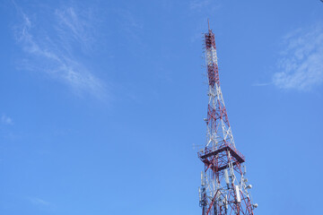 Tall Red White Telecommunication Tower Against Clear Blue Sky