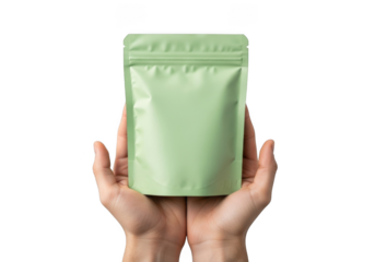 Mockup green pouch packaging in hands for food product, coffee, tea, snack, powder, or supplement presentation, branding, and design isolated on transparent background