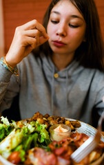 A varied plate of meat, ham, salad, coriander, and burratta