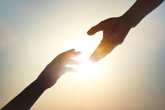 The concept of a helping hand, a helping hand and a helped hand, cooperation, collaboration, teamwork, harmony, cooperation, and volunteer work.
