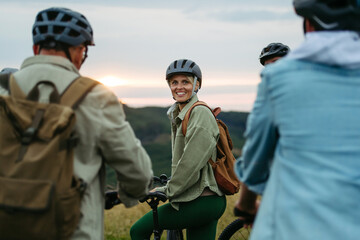 Happy woman during family biking adventure in nature.