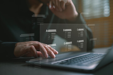 Businessman taking online quiz on laptop with multiple choice options interface, representing...