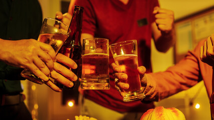 A group of friends toasting with beer glasses at a lively night gathering, surrounded by delicious fried chicken and snacks, symbolizing teamwork, celebration, friendship, joyful social connection.