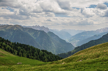 Fototapeta premium Sella mountain range and Sasso Pordoi images from Col Rodella with a cloudy sky in the background, Dolomites, Italy