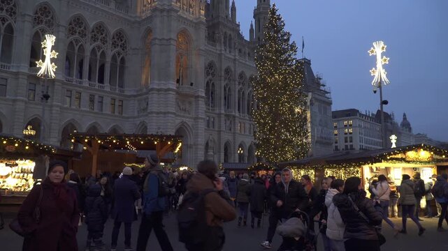 Decorated Christmas Tree on crowded Rathausplatz square during the traditional Christmas market in Vienna,  Austria.