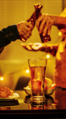 A group of friends toasting with beer glasses at a lively night gathering, surrounded by delicious fried chicken and snacks, symbolizing teamwork, celebration, friendship, joyful social connection.