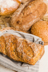 Homemade natural breads. Different kinds of fresh bread as background, perspective view with copy space