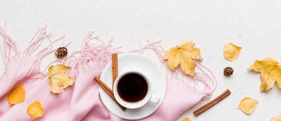 Flat lay composition with colorful Autumn cup of coffee and leaves on a color background. top view