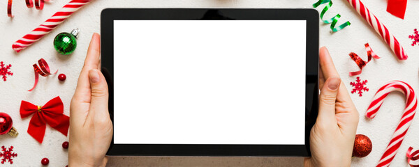 Christmas online shopping from home, female hands holding tablet pc with blank white display top...