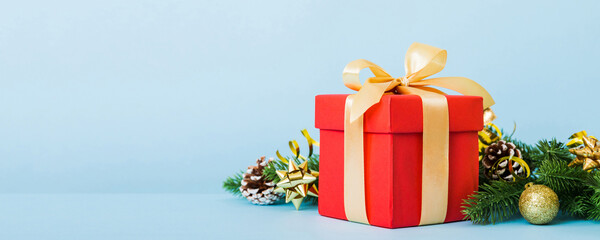 New Year Christmas mood, gift box, branches of a christmas tree, New Year decorations on a colored...