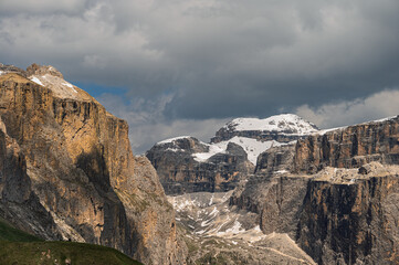 Sella mountain range and Sasso Pordoi images from Col Rodella with a cloudy sky in the background, Dolomites, Italy