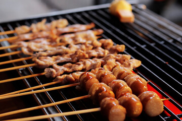 Thai-Asian style barbecue meatballs called 'Mala' served with a rich chili sauce sold as street food.