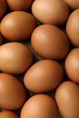 Many raw chicken eggs on table, above view