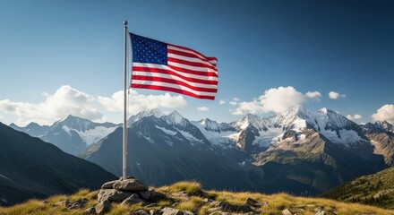 American flag flying proudly on a mountain peak with snowy mountains under a bright sunny sky